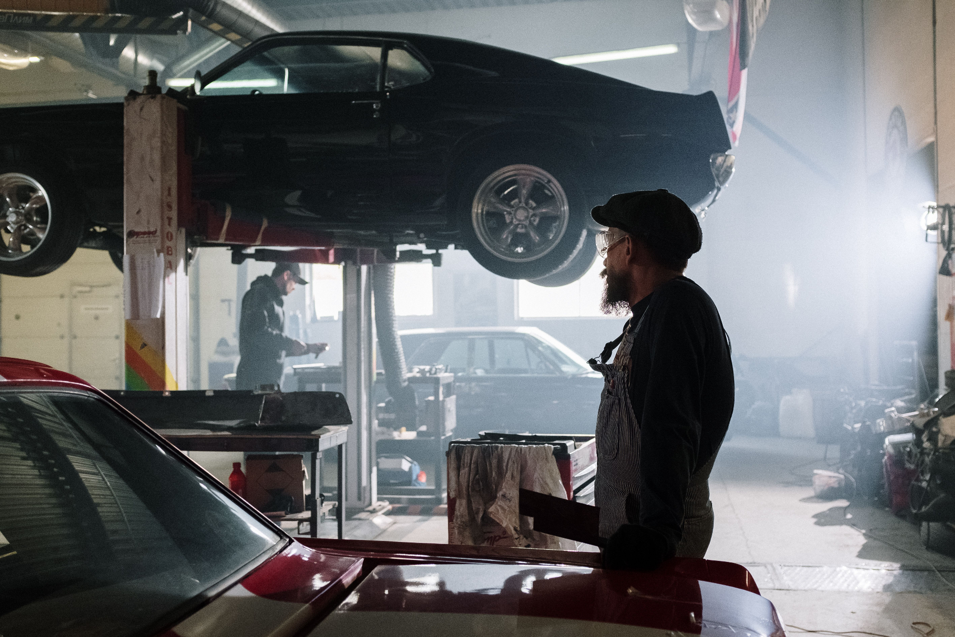 Busy independent auto repair shop interior with cars on lifts